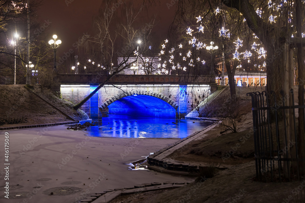 Night winter view of the Alexander bridge in Bastion Hill town park in Riga (Latvia). The bridge was built in 1858-1859, enlarged in 1902.