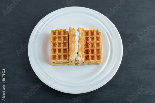 Delicious sweet waffles on white plate