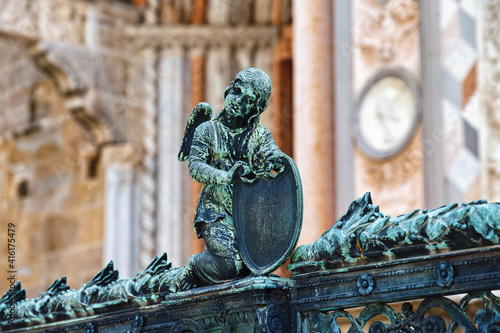 Angel with armor on the metal fence near the Cappella Colleoni (was built with marble elements between 1472 and 1476) of the Basilica di Santa Maria Maggiore (Saint Mary church). Bergamo, Italy. photo