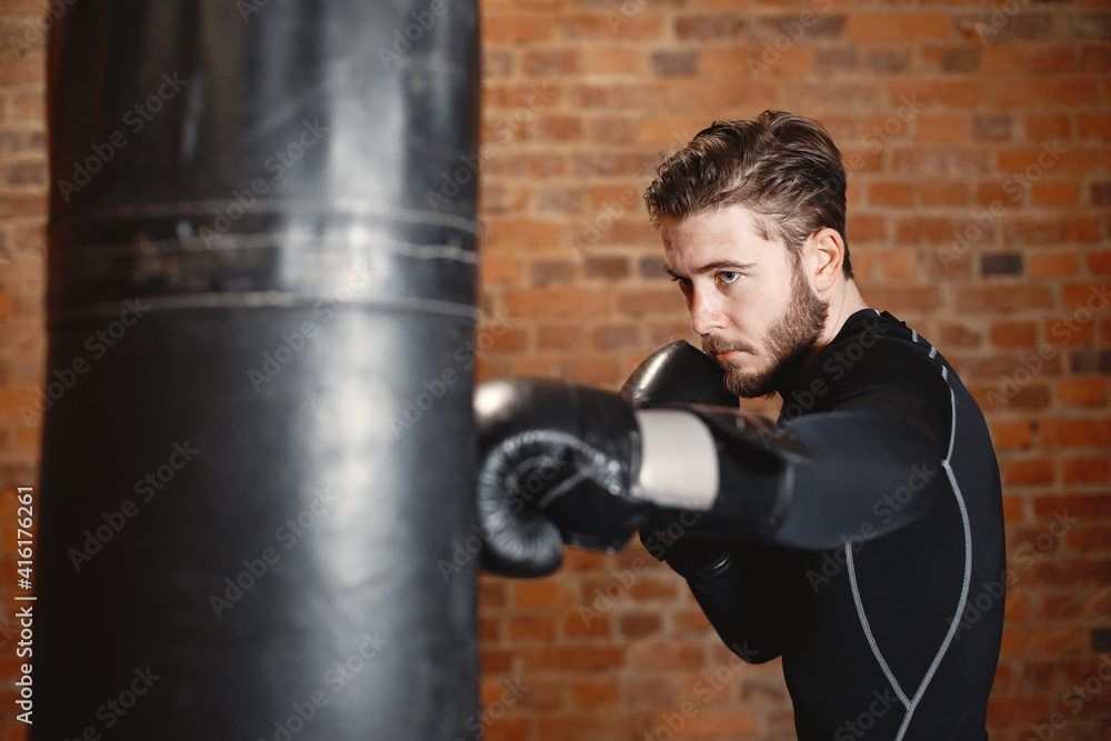 Sporty man boxing. Photo of boxer on a ring. Strength and motivation