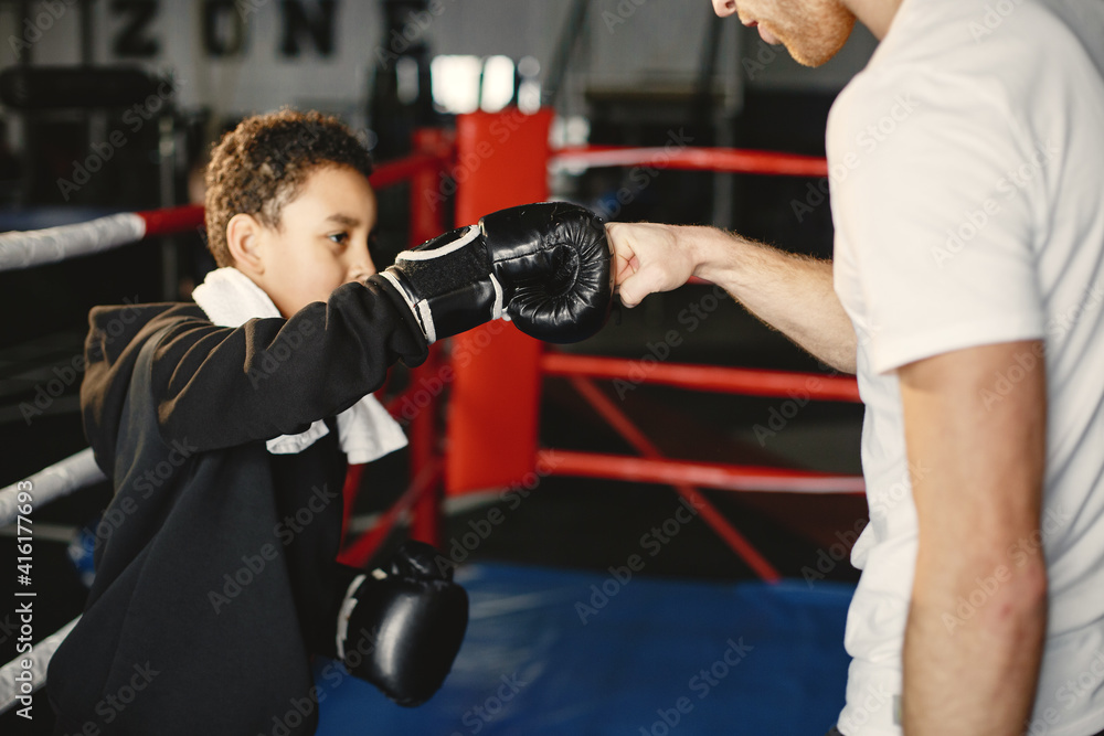 Young hardworking boxer learning to box. Child at sport center. Kid taking up a new hobby