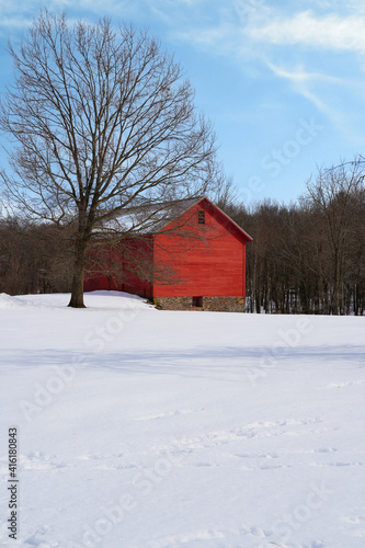 View of a traditional red barn in winter after a snowfall in New Jersey, United States © eqroy