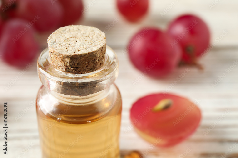 Bottle of natural grape seed oil on white table, closeup with space for text. Organic cosmetic Bottle of natural grape seed oil on white table, closeup with space for text. Organic cosmetic