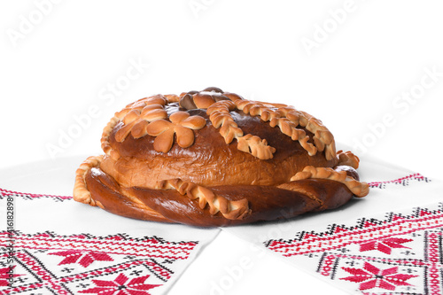 Rushnyk with korovai on white background. Ukrainian bread and salt welcoming tradition photo