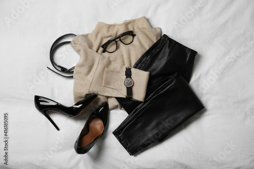 Stylish look with cashmere sweater, flat lay. Women's clothes and accessories on fabric