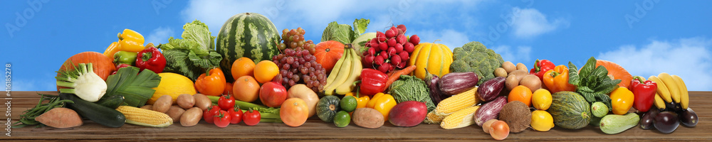 Assortment of fresh organic fruits and vegetables on wooden table outdoors. Banner design Assortment of fresh organic fruits and vegetables on wooden table outdoors. Banner design