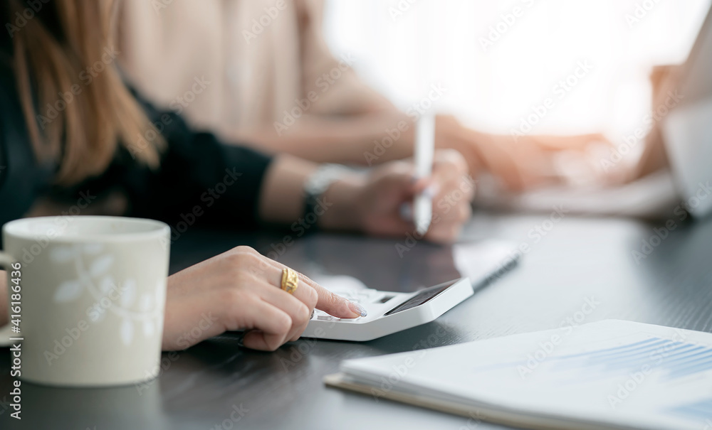 Closeup image of woman hand using calculator while sitting at office desk. Closeup image of woman hand using calculator while sitting at office desk.