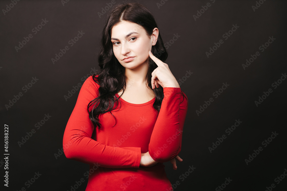 Fototapeta premium Doubtful pensive woman, background with free space