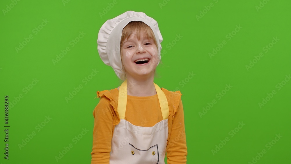 Child girl dressed cook chef baker in apron and hat laughing out loud after hearing funny joke, feeling positive carefree amused isolated on chroma key background. Cooking school, children education Child girl dressed cook chef baker in apron and hat laughing out loud after hearing funny joke, feeling positive carefree amused isolated on chroma key background. Cooking school, children education