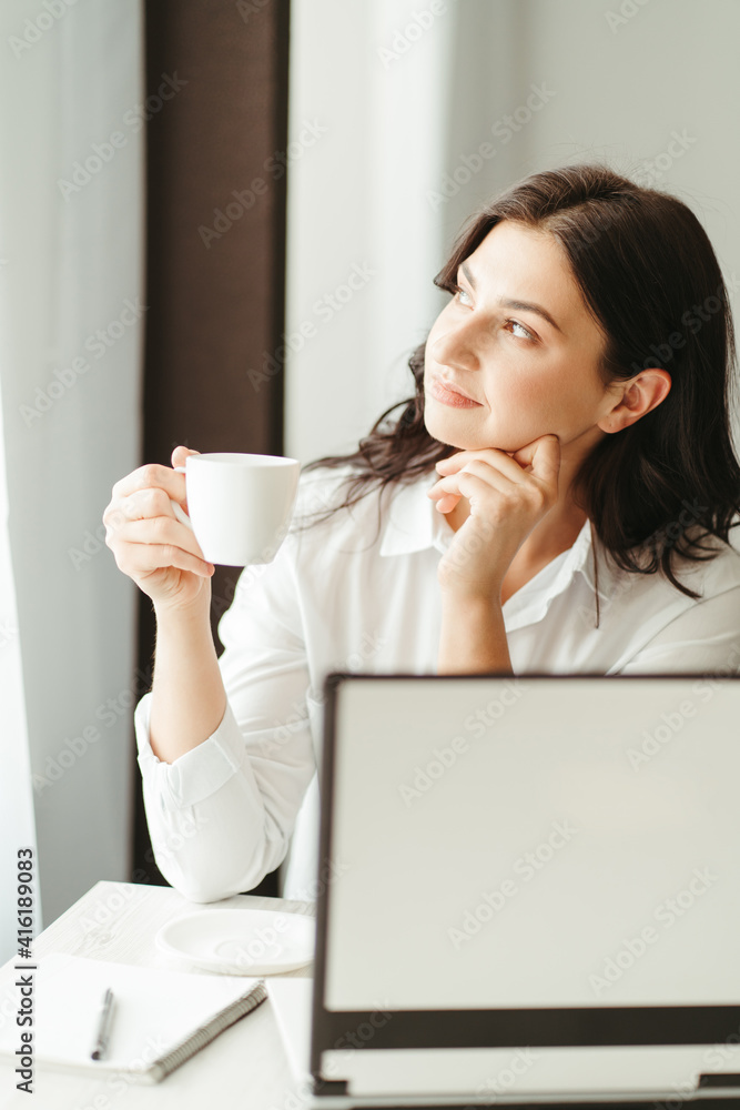 Woman enjoying coffee while working Woman enjoying coffee while working