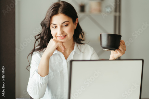 Woman enjoying coffee while working
