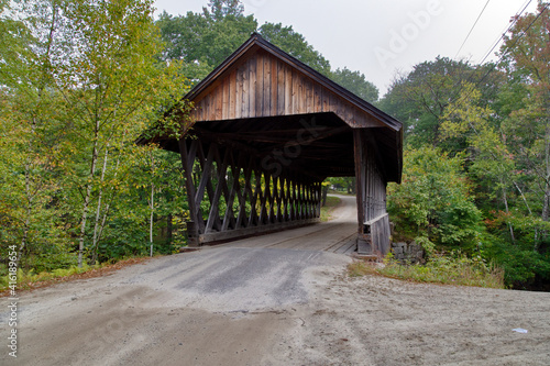 Rustic covered wooden bridge on a gray day
