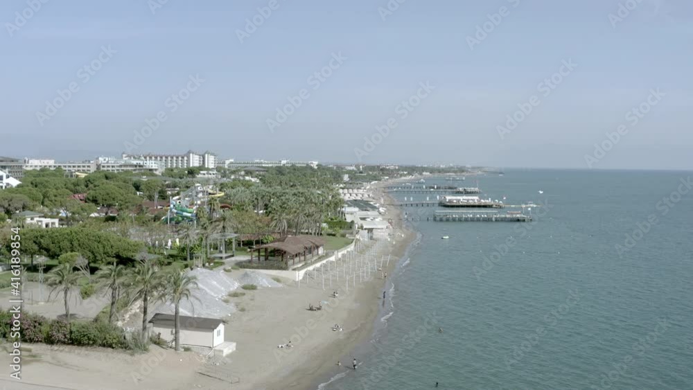Drone video of a beautiful beach on the Mediterranean sea. Sandy beach against the crashing waves of the sea in the seascape. Aerial view Antalya Turkey. Drone video of a beautiful beach on the Mediterranean sea. Sandy beach against the crashing waves of the sea in the seascape. Aerial view Antalya Turkey.