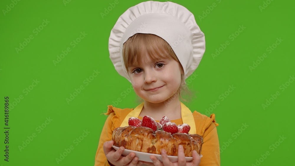 Portrait of little child girl kid dressed as professional cook chef baker with tasty strawberry pie isolated on chroma key background. Concept of sweet nutrition food, cooking school, education Portrait of little child girl kid dressed as professional cook chef baker with tasty strawberry pie isolated on chroma key background. Concept of sweet nutrition food, cooking school, education