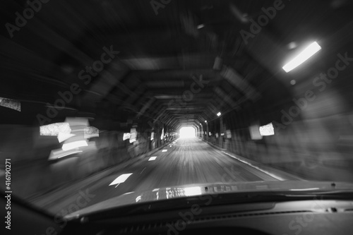 Driving through a covered bridge with blurred lights