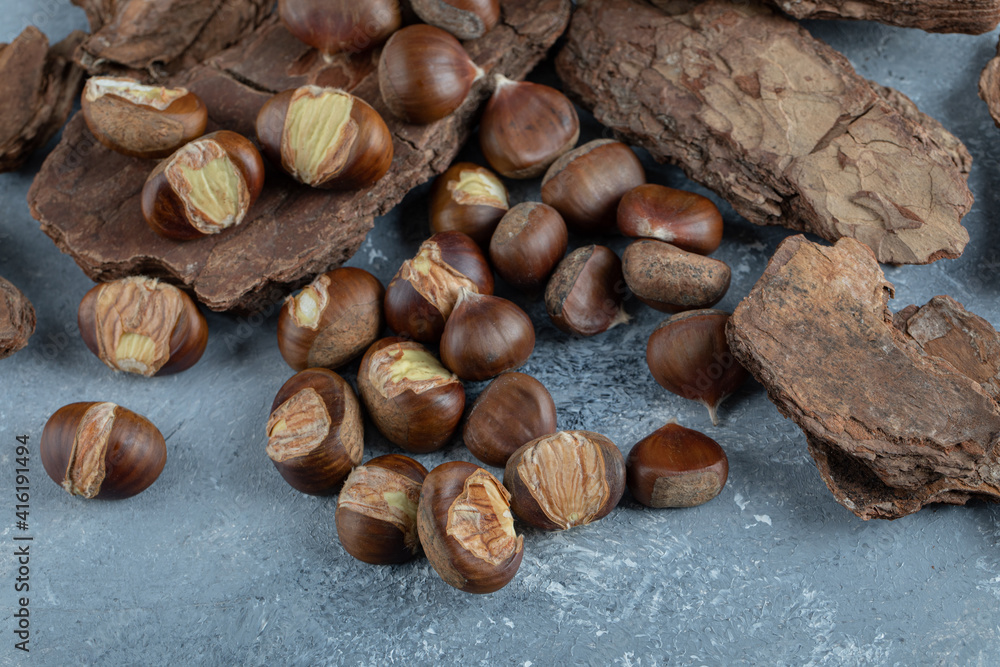 Delicious healthy chestnuts on a tree bark Delicious healthy chestnuts on a tree bark