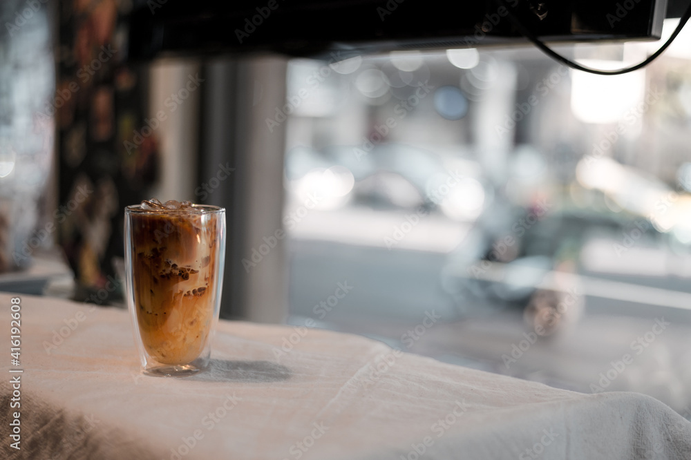 glass of coffee with milk on the table glass of coffee with milk on the table