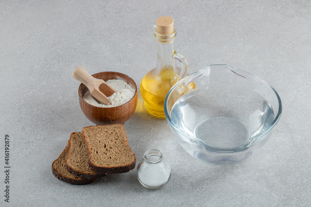 A glass plate of water with slices of bread and oil A glass plate of water with slices of bread and oil