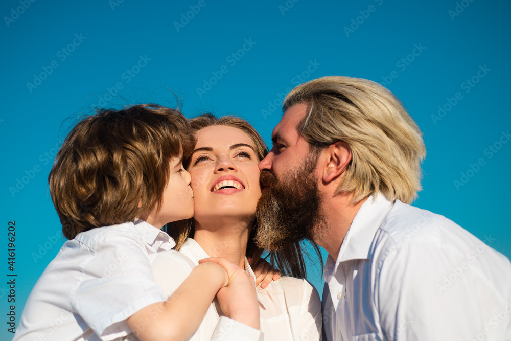 Kids love. Mothers day. Parenting concept. Happy family. Motherhood fatherhood. Son and dad kiss mother. Young family with child.