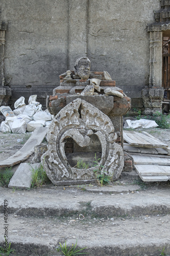 Ancient sculpture and head of the buddha in the temple, Sangklaburi, Thailand. photo