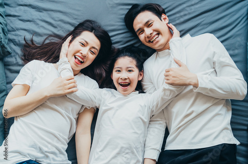 Happy Asian family portrait with mother, father and daughter