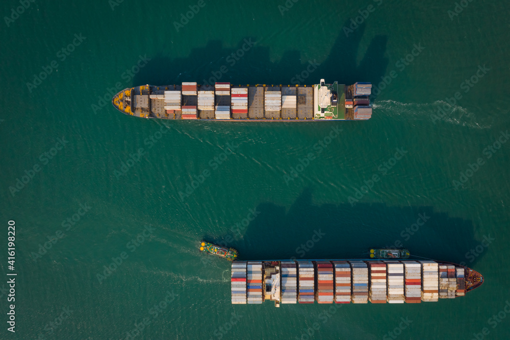 Fototapeta premium Aerial top view from drone, Container ship sailing on the green sea