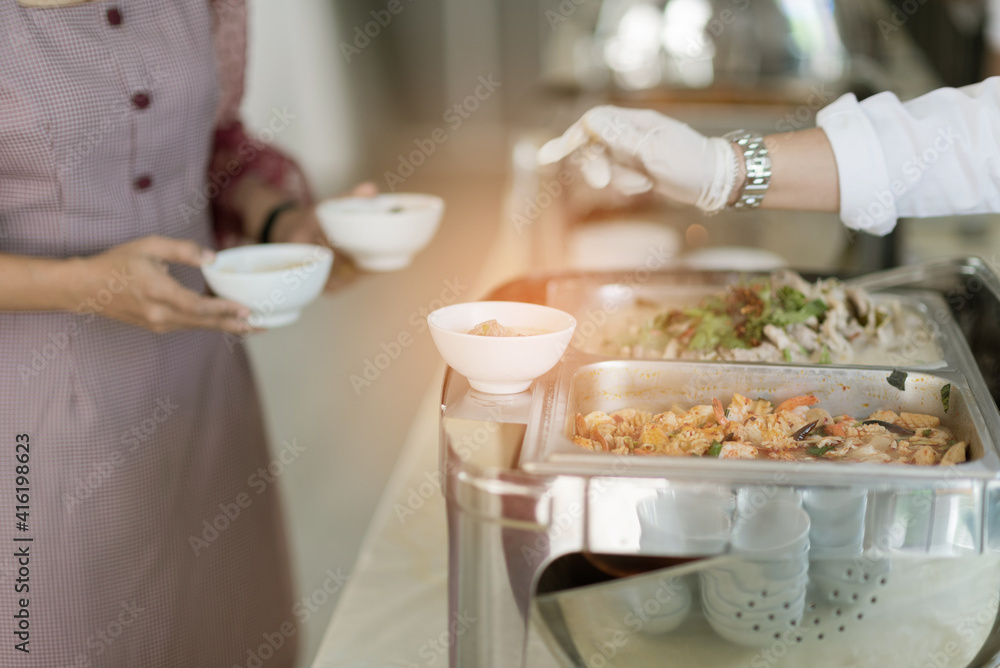 scooping the food, catering, dinner time scooping the food, catering, dinner time