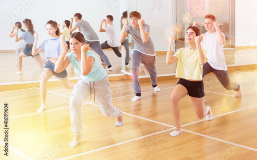 Group of teenage boys and girls enjoying dance class together © JackF