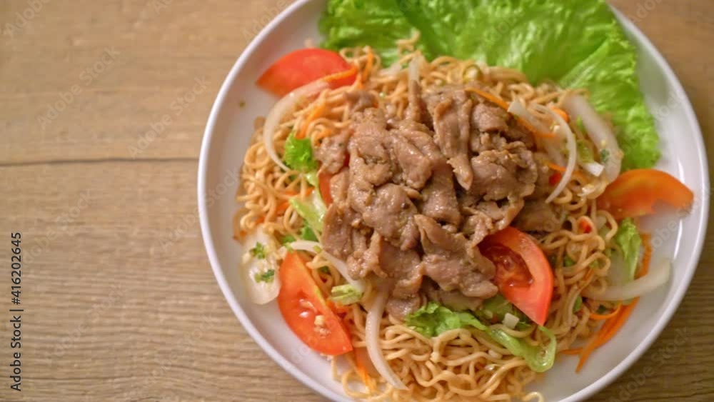 instant noodle spicy salad with pork on white plate - Asian food style instant noodle spicy salad with pork on white plate - Asian food style
