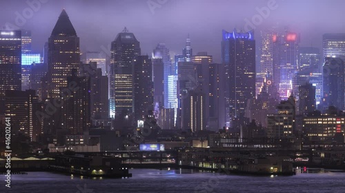 Low clouds and fog roll across midtown Manhattan at night, dark future concept timelapse