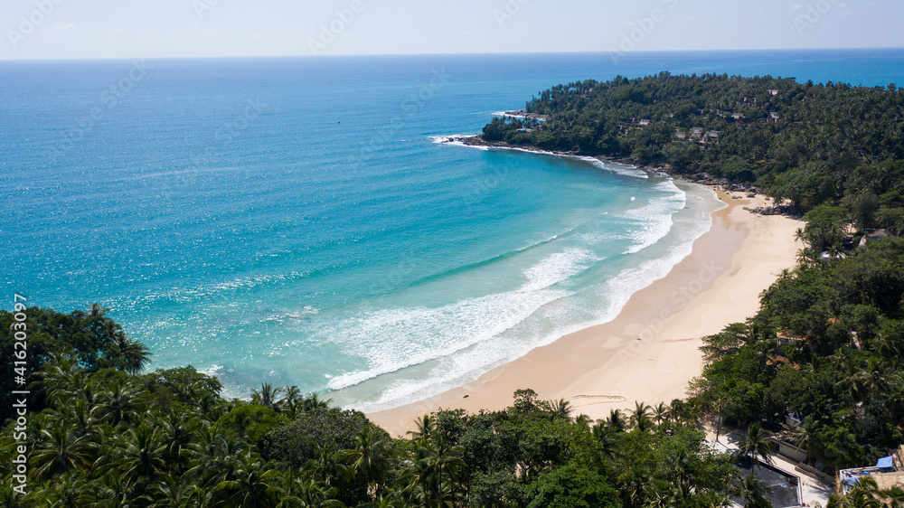Aerial: Surin beach is a beautiful white-sand beach which is located at Phuket, Thailand