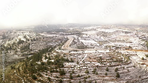 Jerusalem high hills in the snow aerial view
,drone view over mevasert zion close to Jerusalem covered with snow, February 2021
 photo