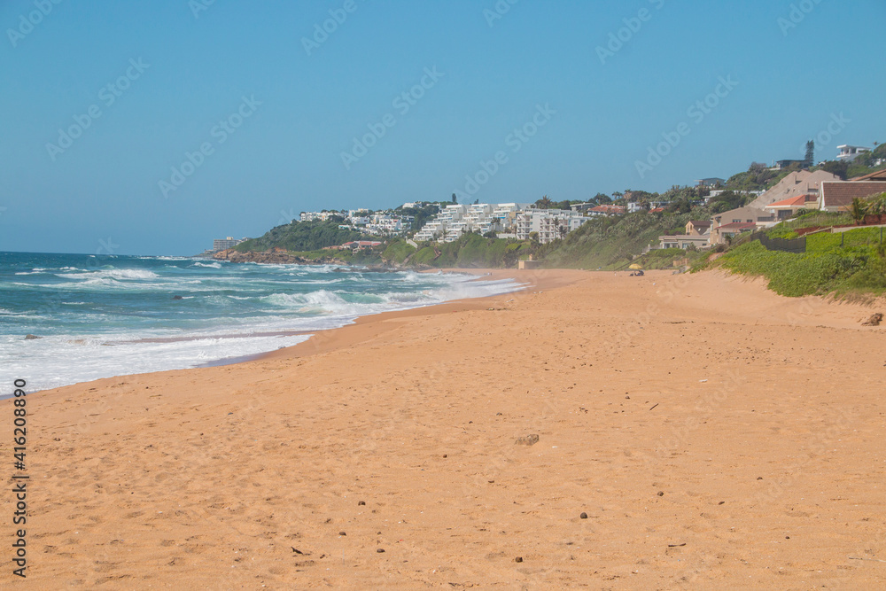 Golden Sandy Beach and Sea with Residential Buildings