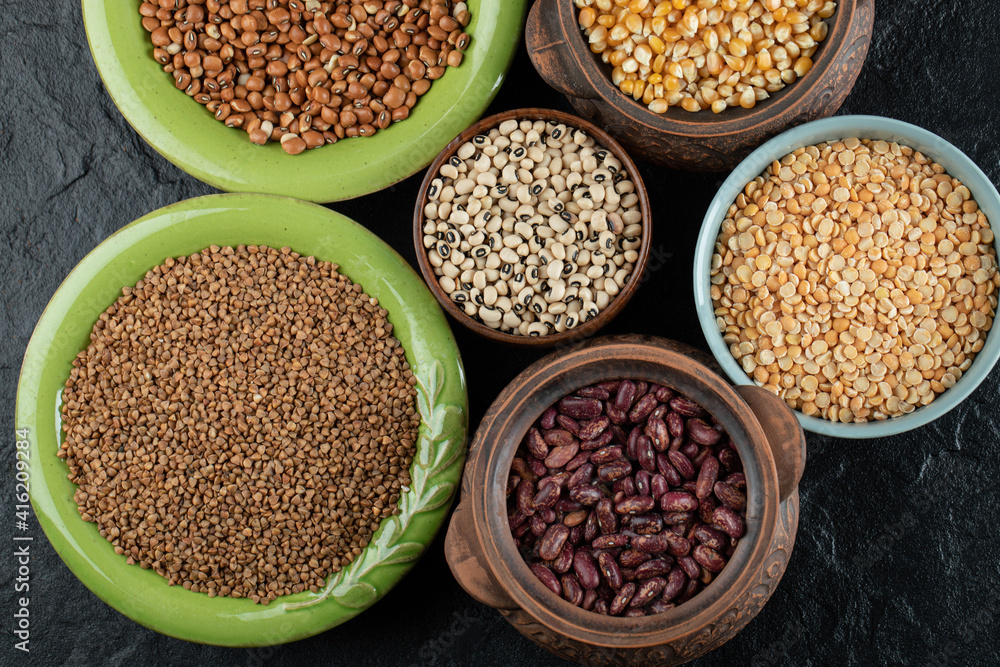 Different kinds of beans in colorful bowls Different kinds of beans in colorful bowls