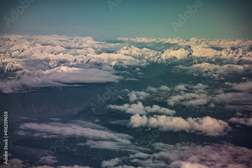 aerial view of clouds and snow cap mountains and lakes