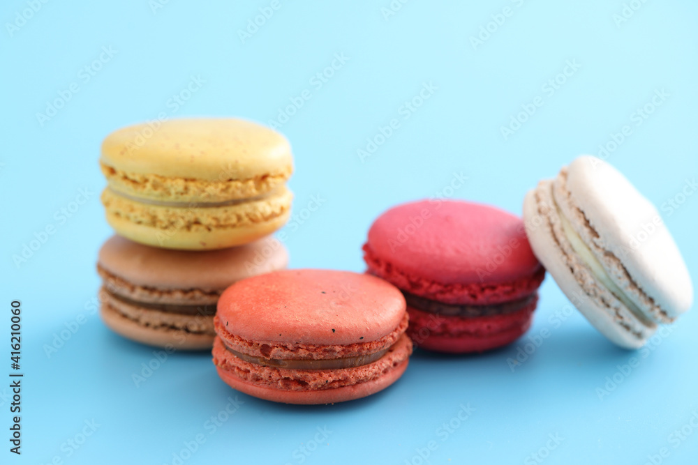 Colorful macarons isolated in blue background Colorful macarons isolated in blue background