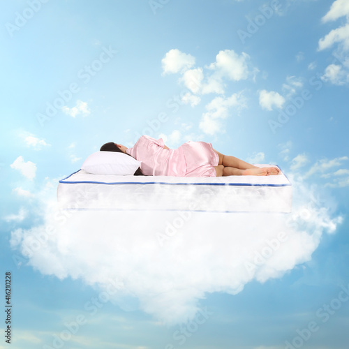 Young woman sleeping on mat...