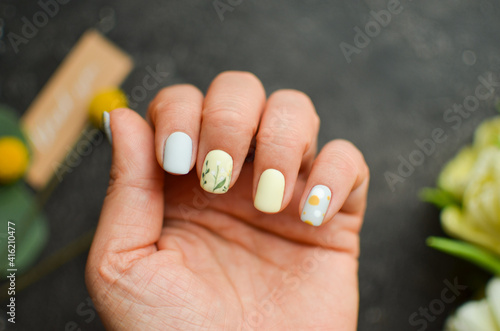 Woman s hands with a colorful patterns on the nails. 2022-2023 colors trend. Top view. A place for text. 