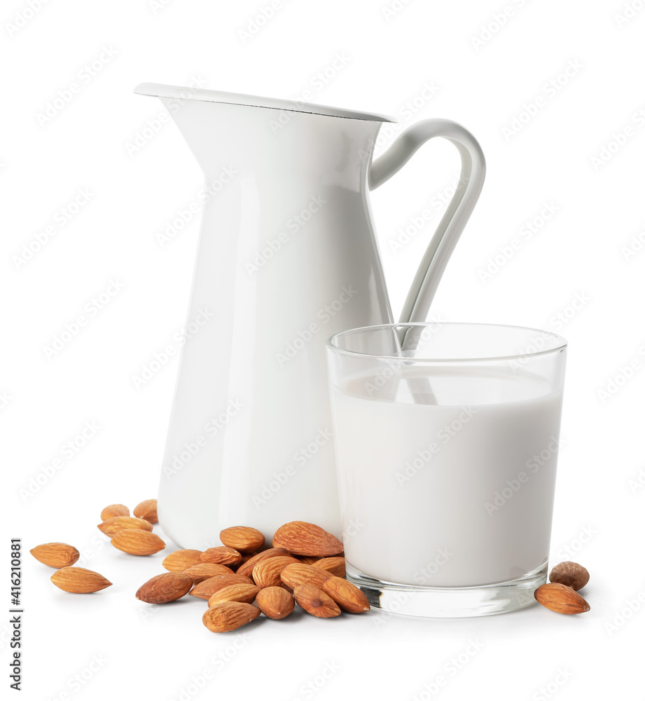 Glass and jug of tasty almond milk on white background Glass and jug of tasty almond milk on white background