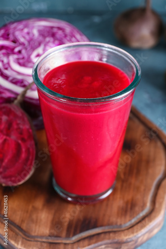 Glass of healthy smoothie with vegetables on color background, closeup