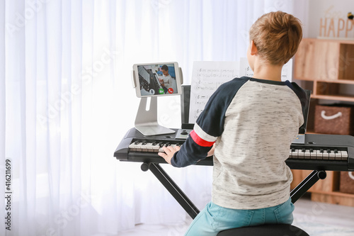 Little boy studying music w...