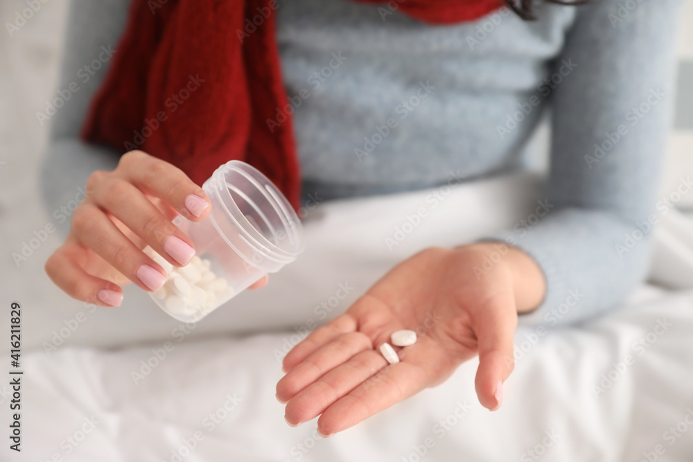 Sick young woman with pills at home, closeup Sick young woman with pills at home, closeup