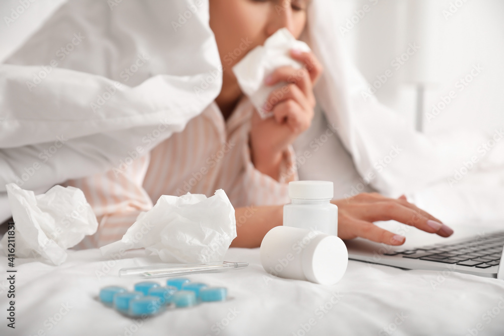 Sick woman with laptop working at home Sick woman with laptop working at home