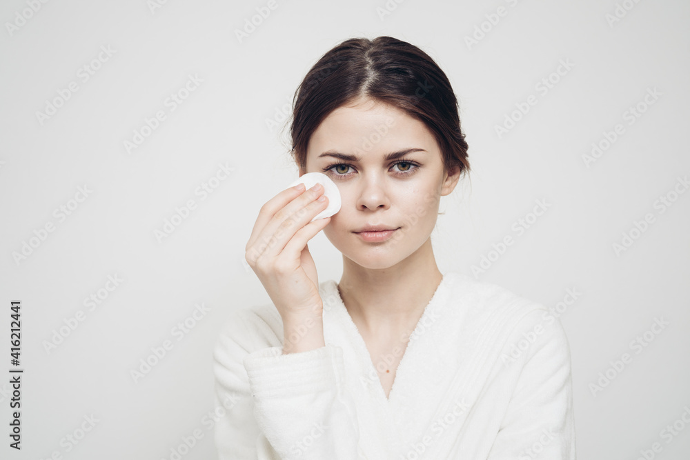 attractive woman with sponge and in white dressing gown attractive woman with sponge and in white dressing gown
