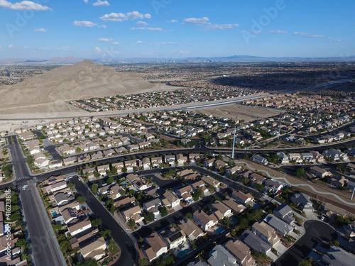 A lone mountain rises above a desert suburb