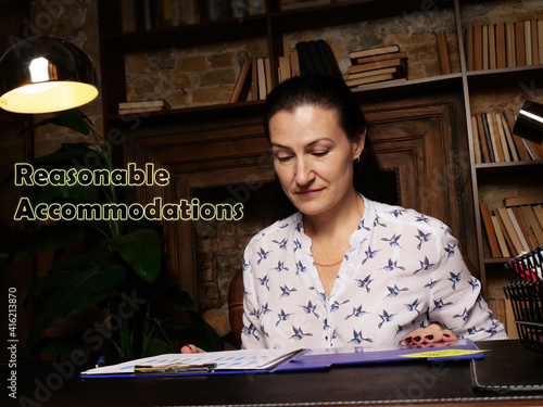 Business concept about Reasonable Accommodations Female office workers with yellow shirt holding and writing documents on office desk