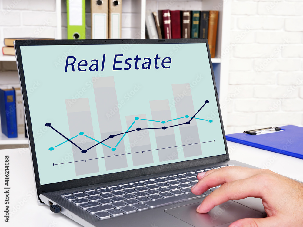 Financial concept about Real Estate with phrase on the sheet. Financial concept about Real Estate with phrase on the sheet.