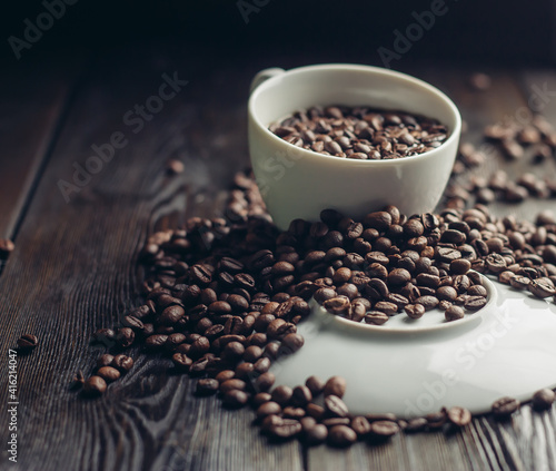 white cup and saucer coffee beans on a wooden background aroma drink