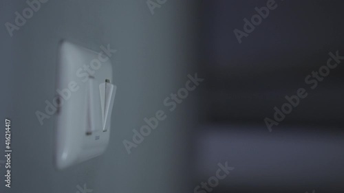 4K Close up hand push switch on-off electric light. Concept of energy and power saving. photo