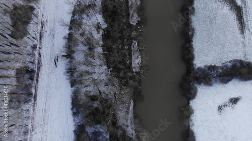 winter landscape by the river. Trees in hoarfrost, sunny day, blue sky. beautiful french snowy countryside. Snowy frosty river bank landscape at the woods Winter forest on the river